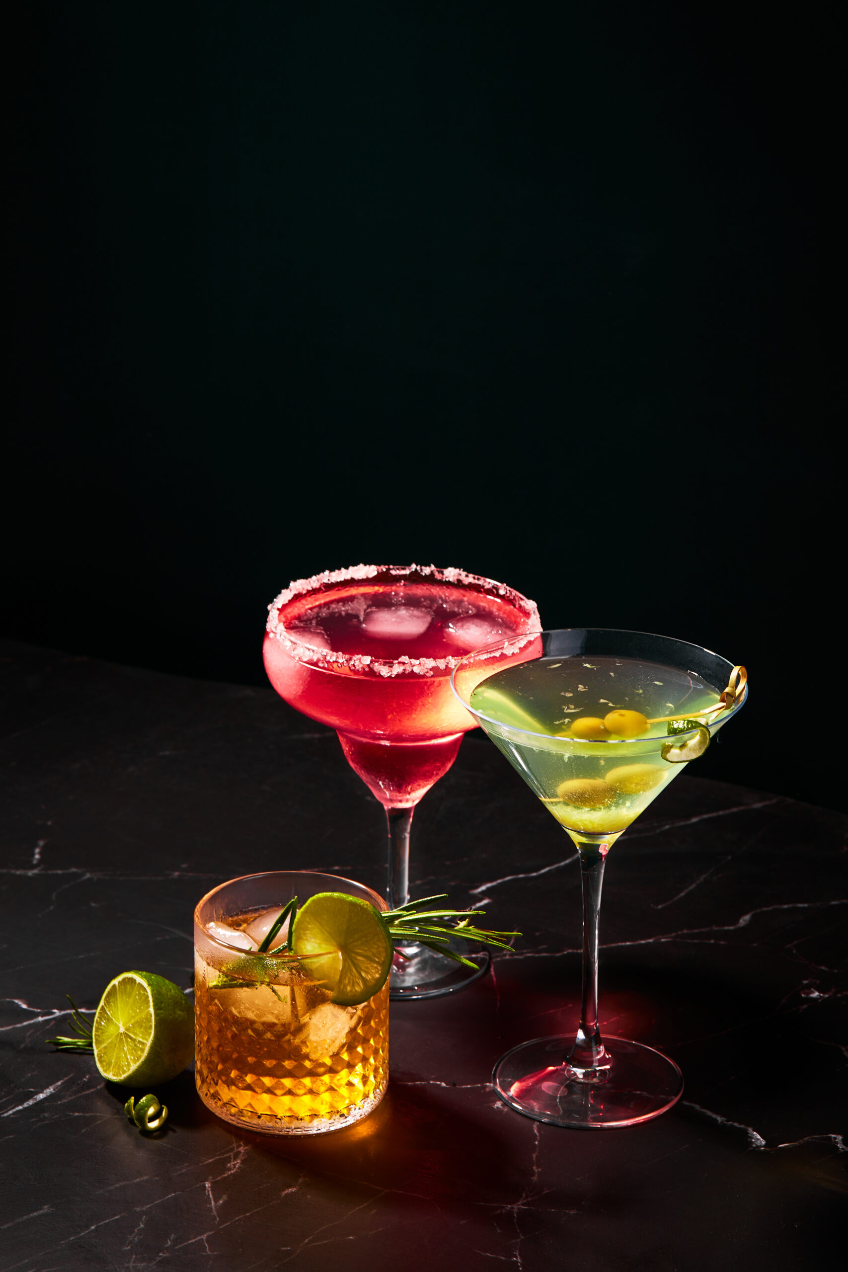 Alcoholic and non-alcoholic cocktails on a dark marble table. Summer refreshments.